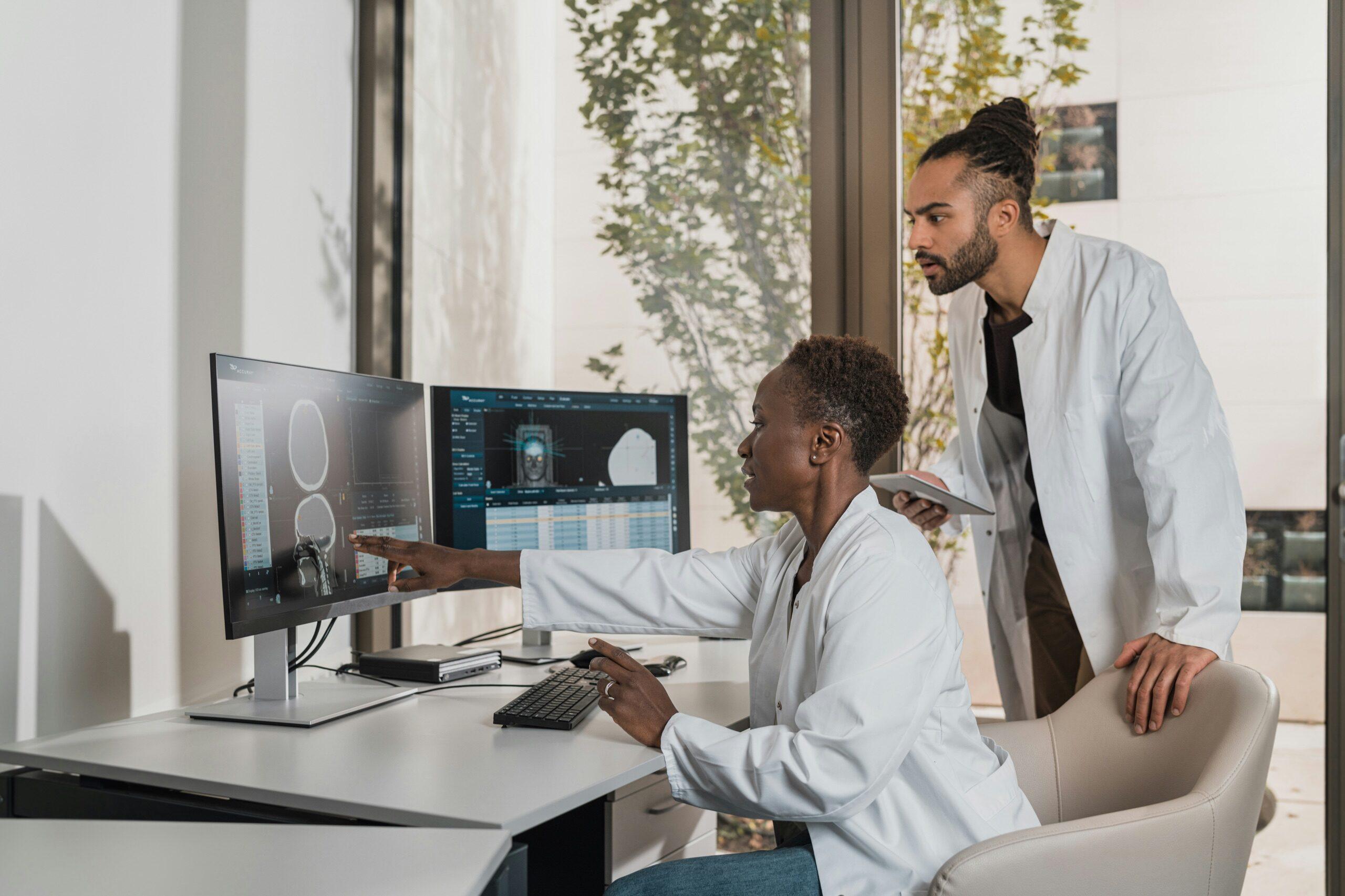 Medical professionals reviewing clinical imaging on dual monitors