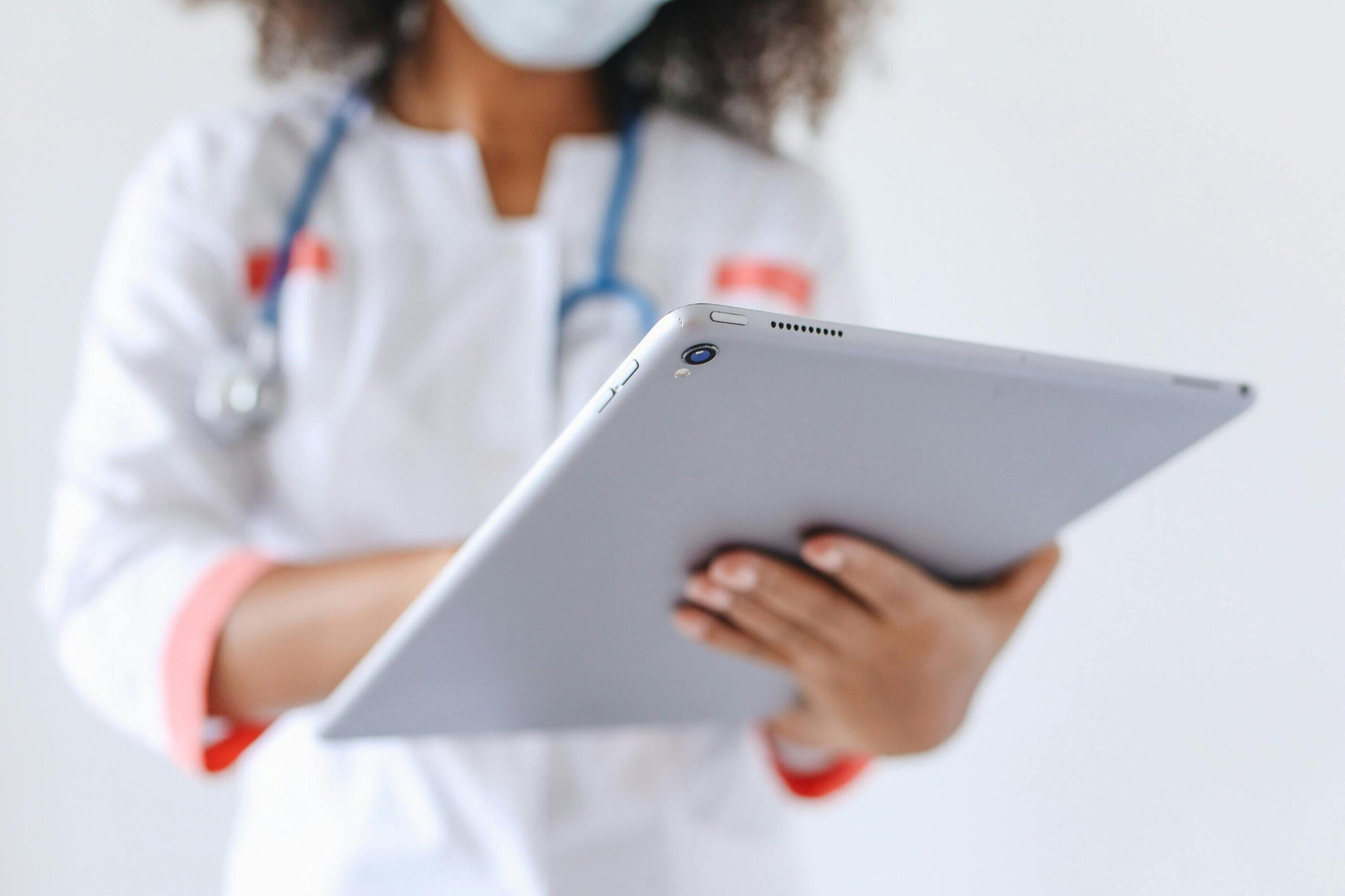 Healthcare provider with tablet — IT modernization