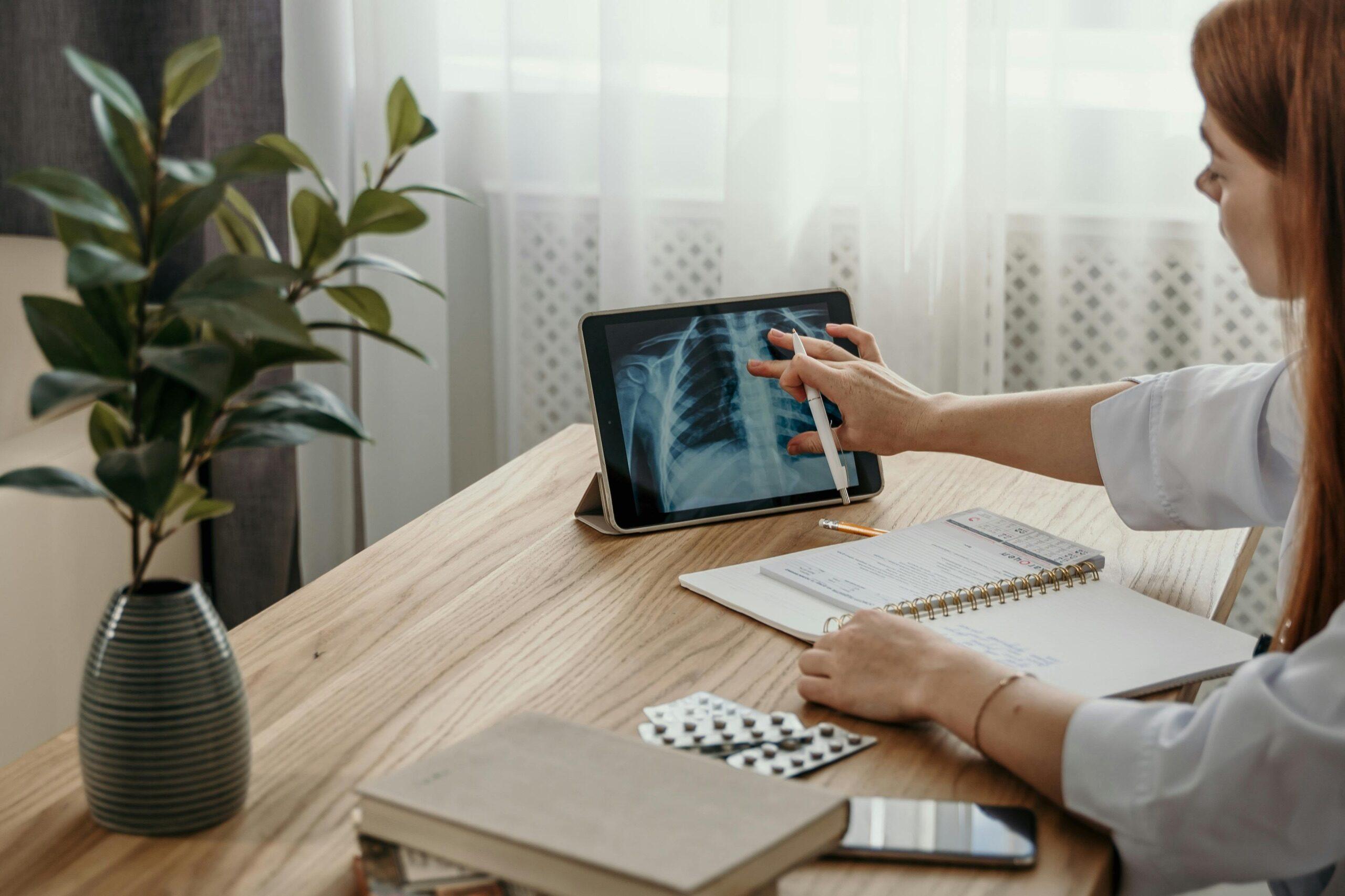 Clinician reviewing a chest X-ray on a tablet