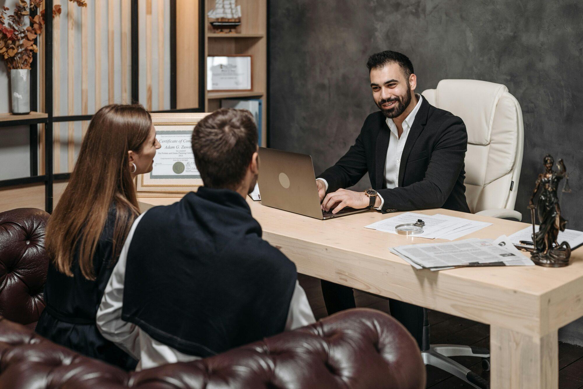 Senior attorney consulting with a colleague in a modern law office